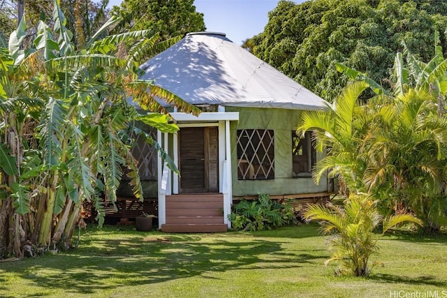 view of outbuilding featuring a lawn