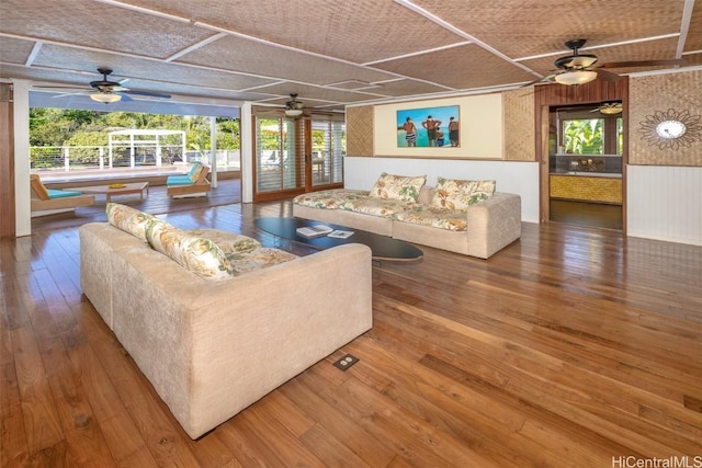 living room featuring hardwood / wood-style flooring and wooden walls