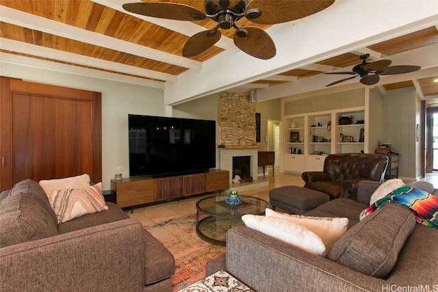 tiled living room with a stone fireplace, wood ceiling, built in features, beamed ceiling, and ceiling fan