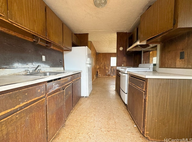 kitchen featuring decorative backsplash, sink, and white appliances