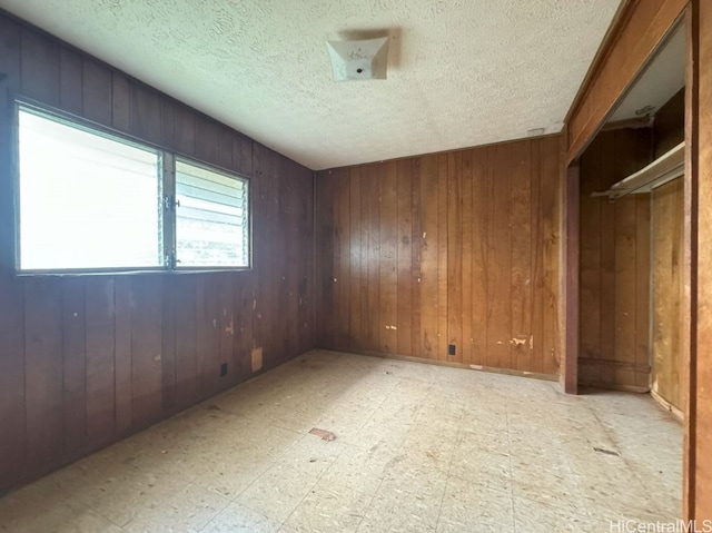 unfurnished room with wooden walls