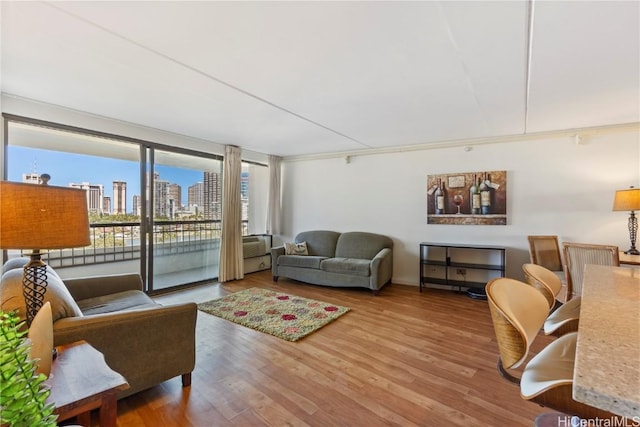 living room with ornamental molding and hardwood / wood-style floors