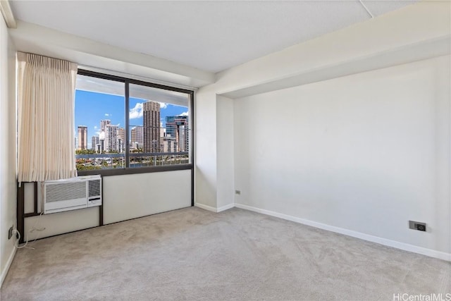 carpeted empty room featuring an AC wall unit