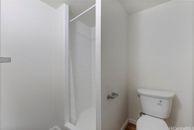 bathroom featuring toilet and a shower