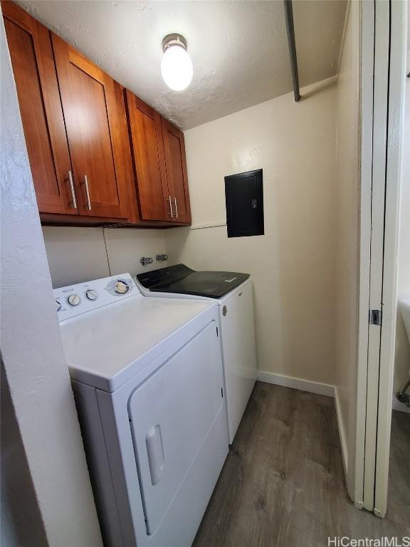 laundry room with cabinets, separate washer and dryer, dark hardwood / wood-style floors, and electric panel