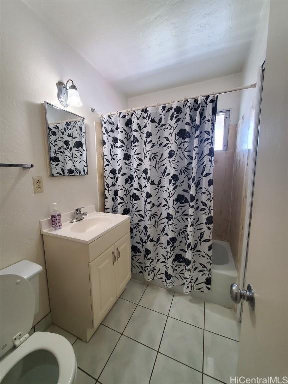 full bathroom with tile patterned flooring, vanity, shower / bath combination with curtain, and toilet