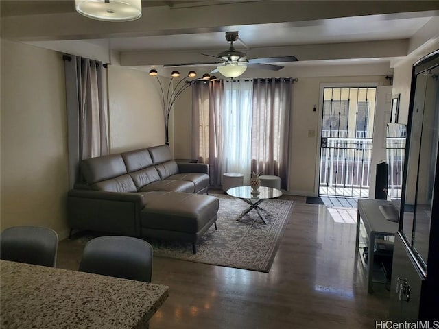 living room with dark wood-type flooring and ceiling fan