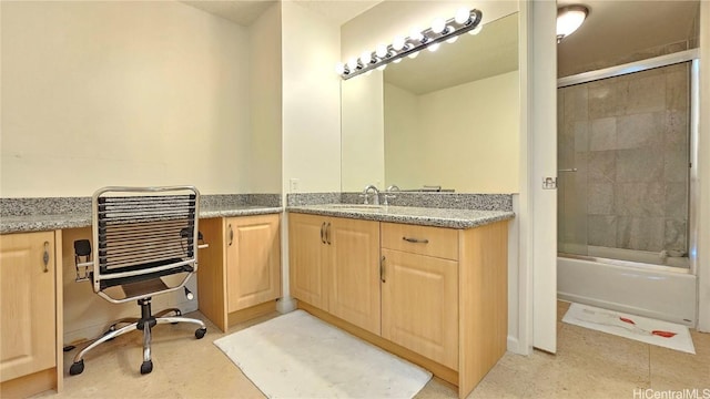 bathroom featuring vanity and shower / bath combination with glass door