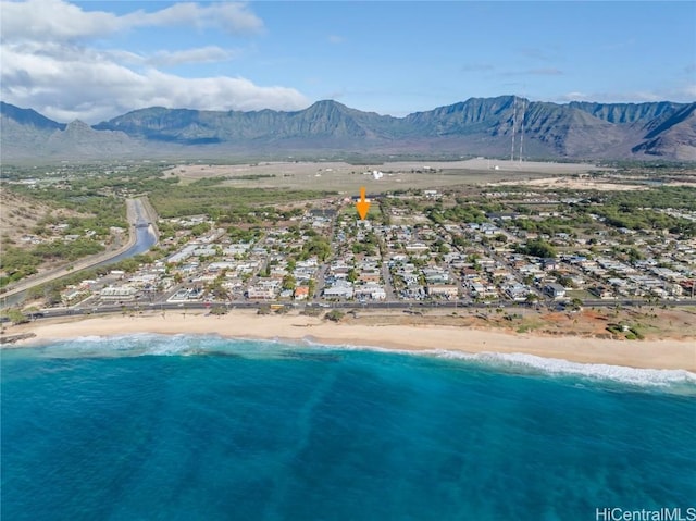 aerial view featuring a water and mountain view and a beach view