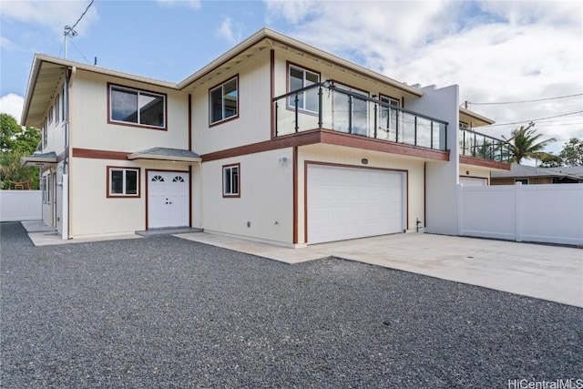 view of front of property with a garage and a balcony