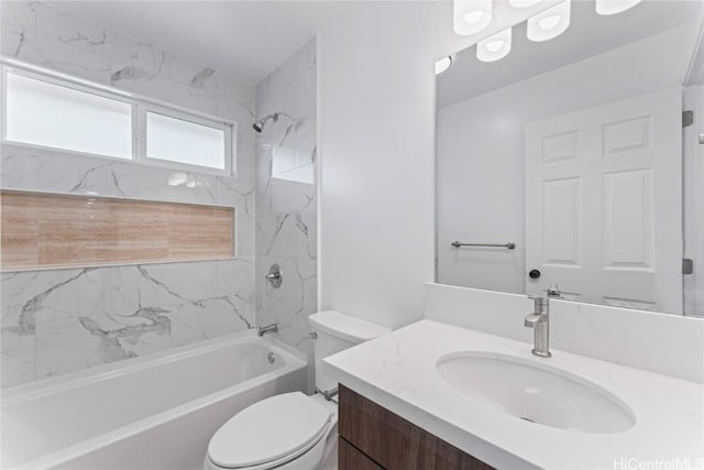 full bathroom with vanity, tiled shower / bath combo, and toilet