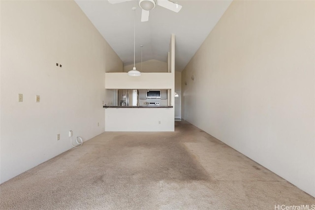 unfurnished living room with light carpet, vaulted ceiling, and ceiling fan