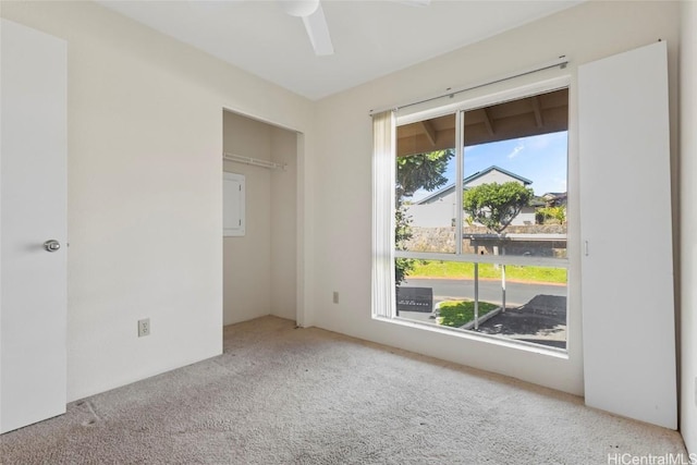 unfurnished bedroom featuring ceiling fan, light colored carpet, and a closet