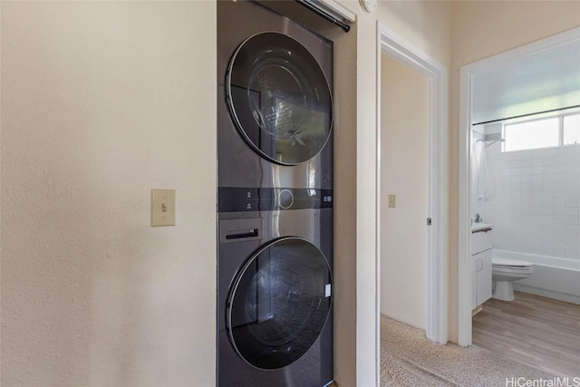 laundry area featuring stacked washer and dryer