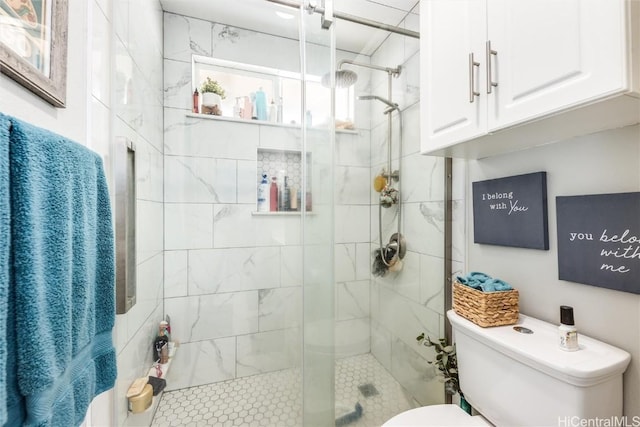 bathroom featuring an enclosed shower and toilet