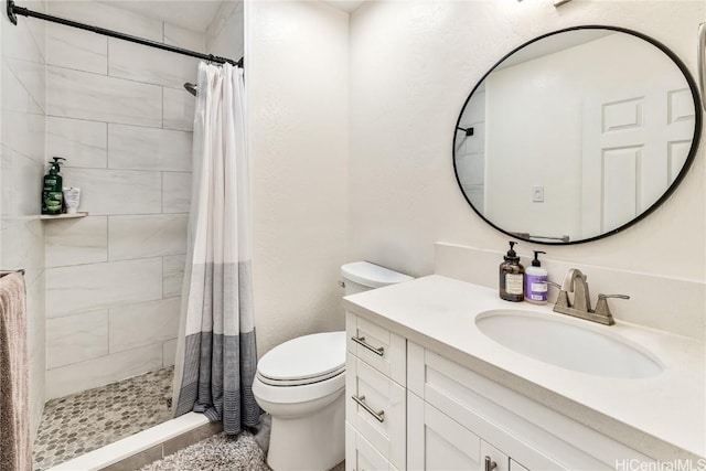 bathroom featuring vanity, toilet, and curtained shower