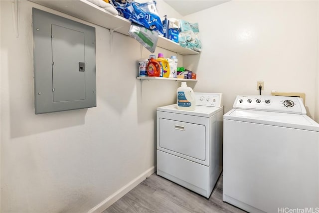 laundry area with separate washer and dryer, electric panel, and light wood-type flooring