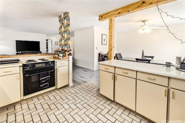 kitchen featuring ceiling fan, black / electric stove, beam ceiling, and cream cabinets