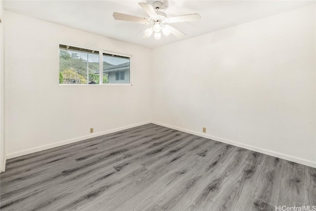 empty room featuring ceiling fan and dark hardwood / wood-style flooring