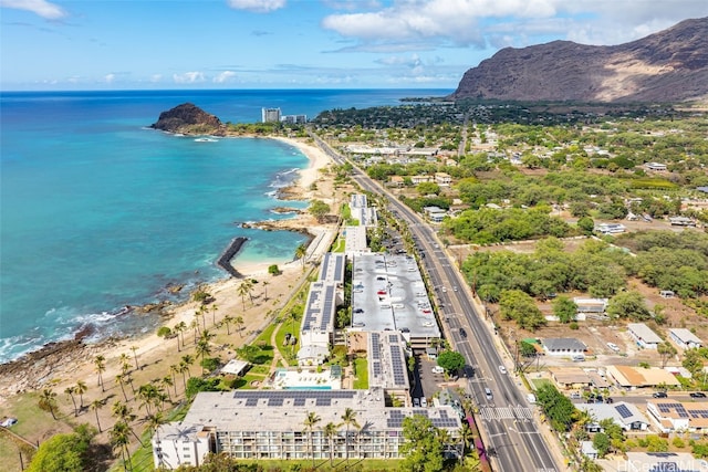 aerial view with a water and mountain view and a view of the beach