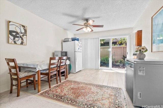 dining room featuring ceiling fan and a textured ceiling