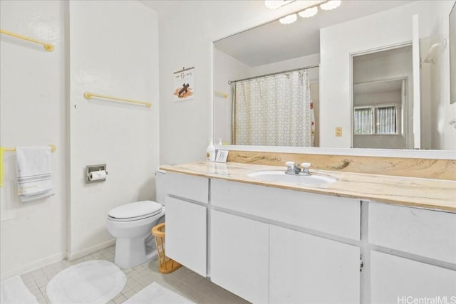 bathroom featuring vanity, tile patterned floors, and toilet