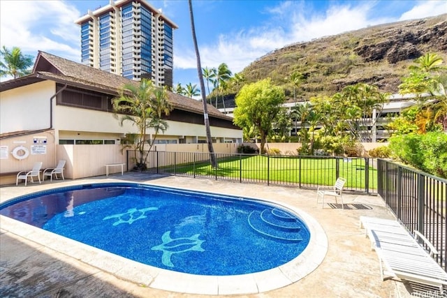 view of swimming pool with a yard and a patio area