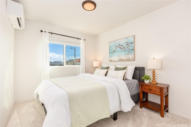 bedroom featuring light carpet and a wall mounted AC