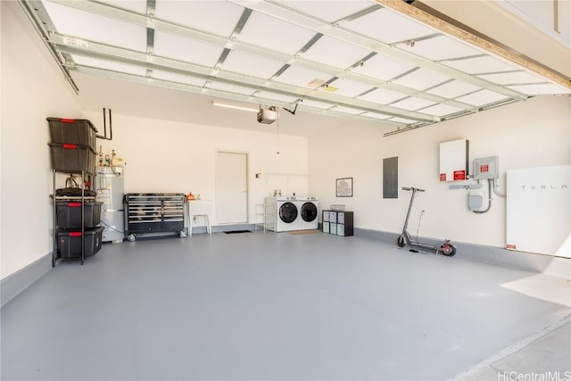 garage featuring washing machine and dryer, a garage door opener, electric panel, and strapped water heater