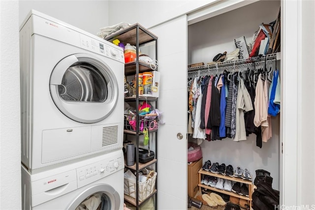 laundry area featuring stacked washing maching and dryer