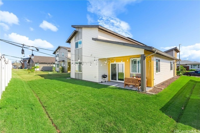 rear view of property featuring a lawn