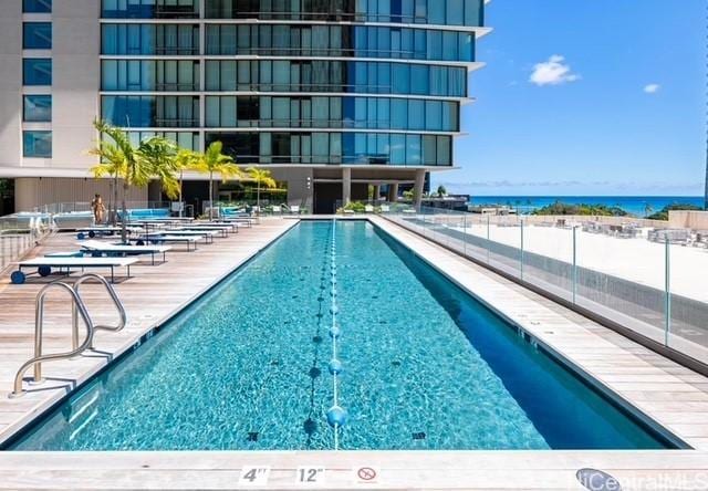 view of swimming pool featuring a water view