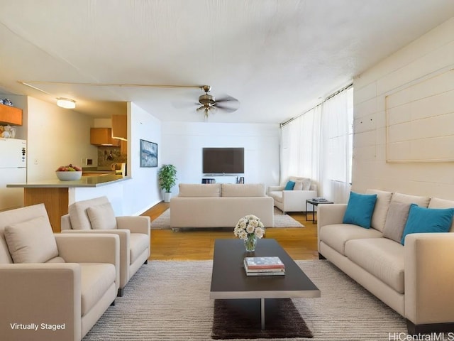 living room featuring ceiling fan and light hardwood / wood-style floors