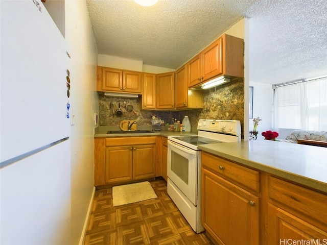 kitchen with dark parquet flooring, decorative backsplash, sink, white appliances, and a textured ceiling