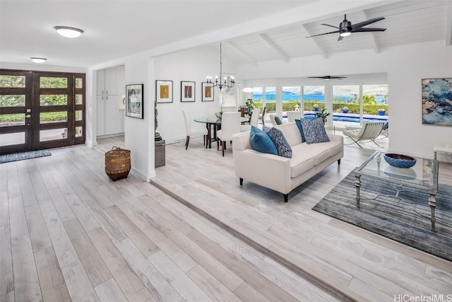 living room featuring french doors, lofted ceiling with beams, wooden ceiling, light hardwood / wood-style floors, and ceiling fan with notable chandelier