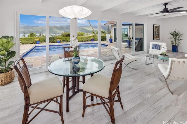 dining area with beamed ceiling, ceiling fan, wooden ceiling, and light wood-type flooring