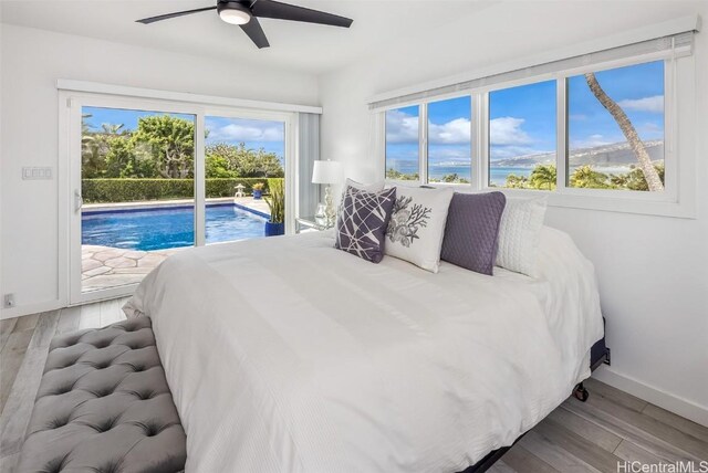 bedroom with a water view, access to exterior, ceiling fan, and light hardwood / wood-style flooring