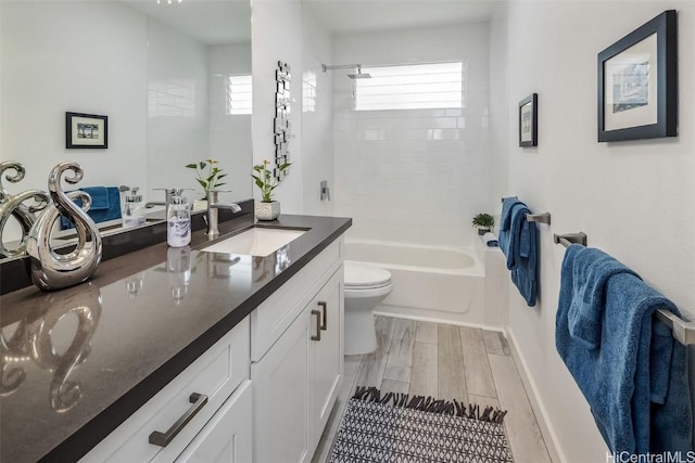 full bathroom featuring vanity, tiled shower / bath combo, and toilet