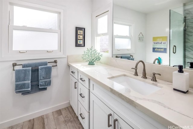 bathroom featuring wood-type flooring, vanity, and walk in shower