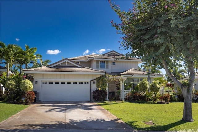 view of front of house featuring a garage and a front yard