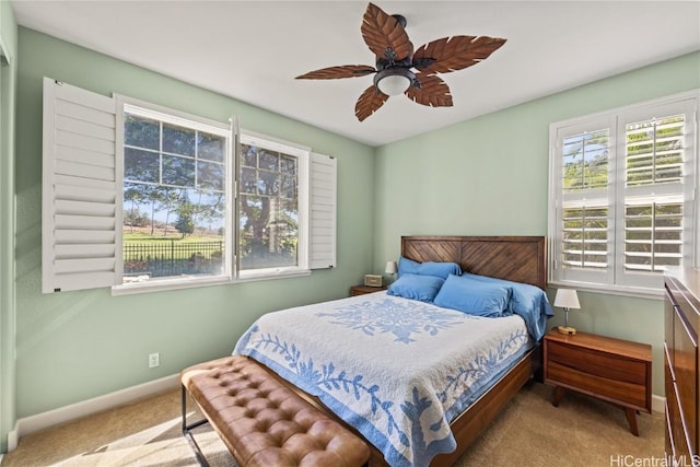 bedroom with ceiling fan and light carpet