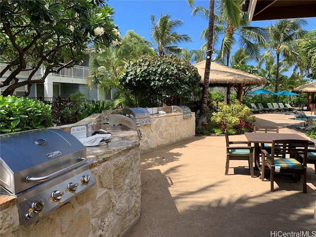 view of patio with a grill, a gazebo, and exterior kitchen