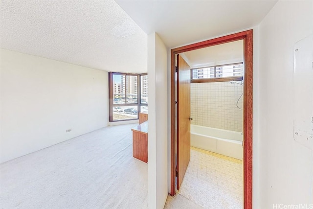 hallway with a textured ceiling