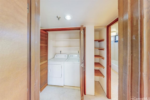 laundry room with washing machine and clothes dryer