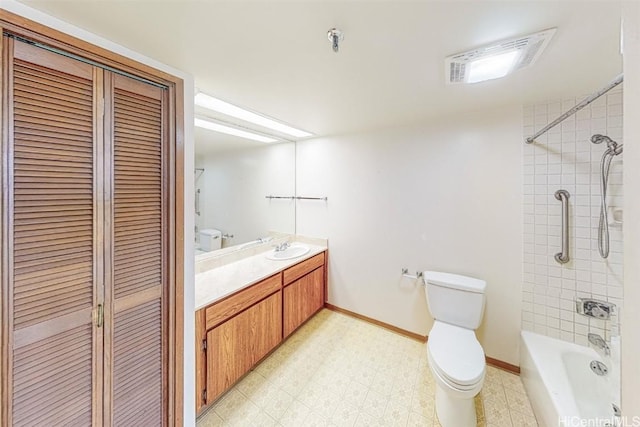 full bathroom with vanity, tiled shower / bath, and toilet