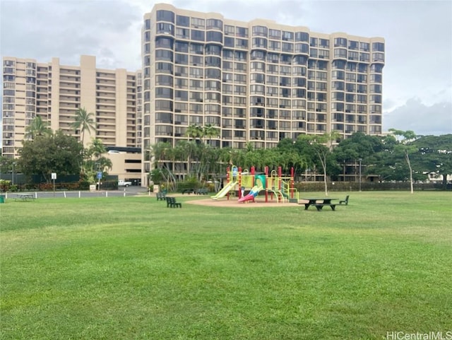 surrounding community featuring a playground and a lawn