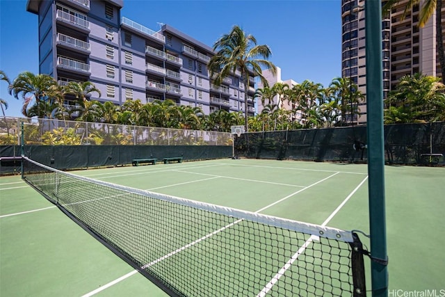 view of tennis court featuring basketball hoop