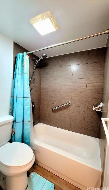 bathroom with shower / bath combination with curtain, wood finished floors, and toilet