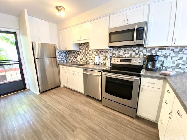 kitchen featuring sink, white cabinets, and stainless steel appliances