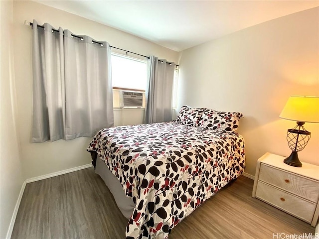 bedroom featuring cooling unit and hardwood / wood-style flooring